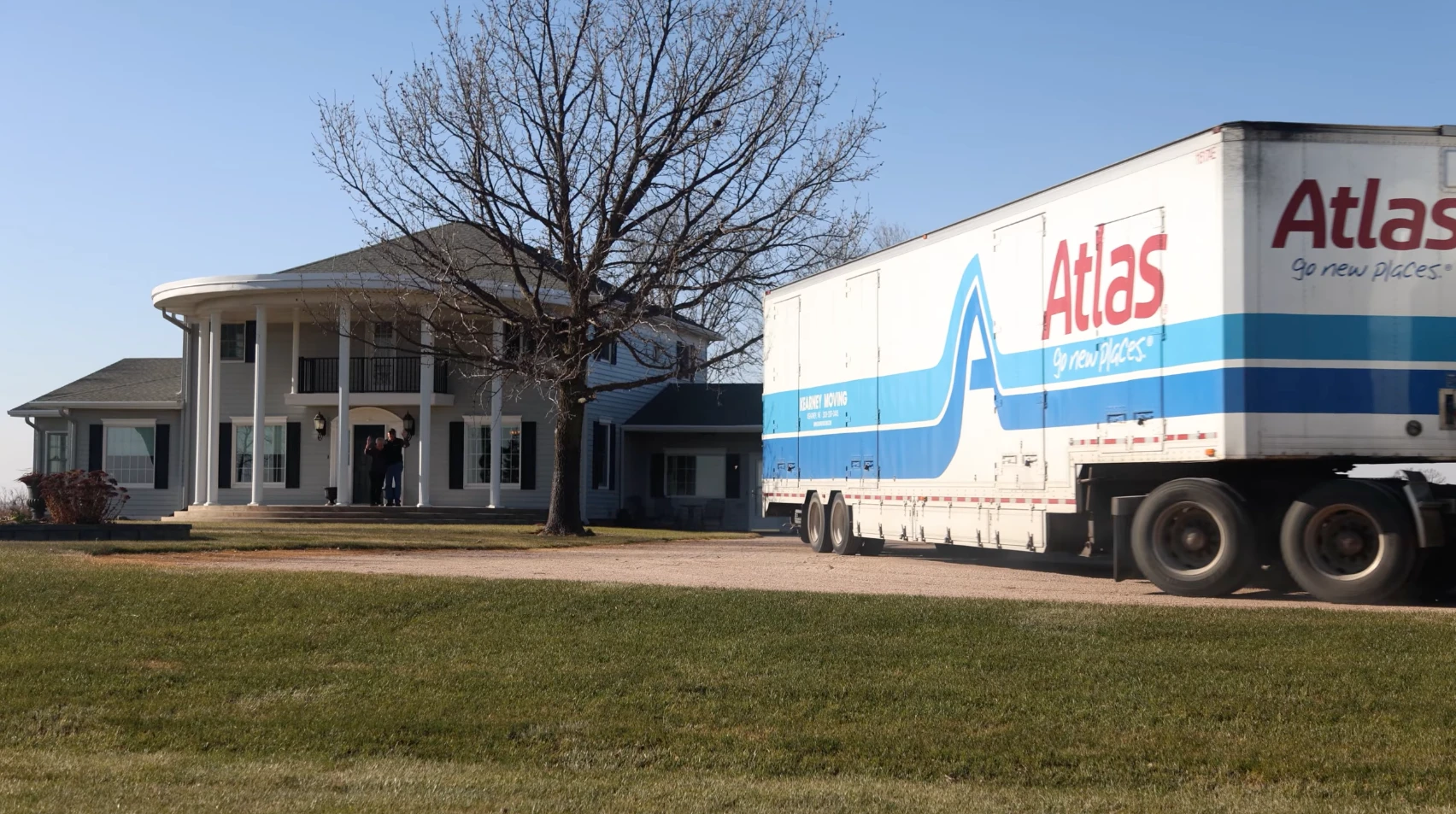 Satisfied Kearney Moving customers waving from front porch